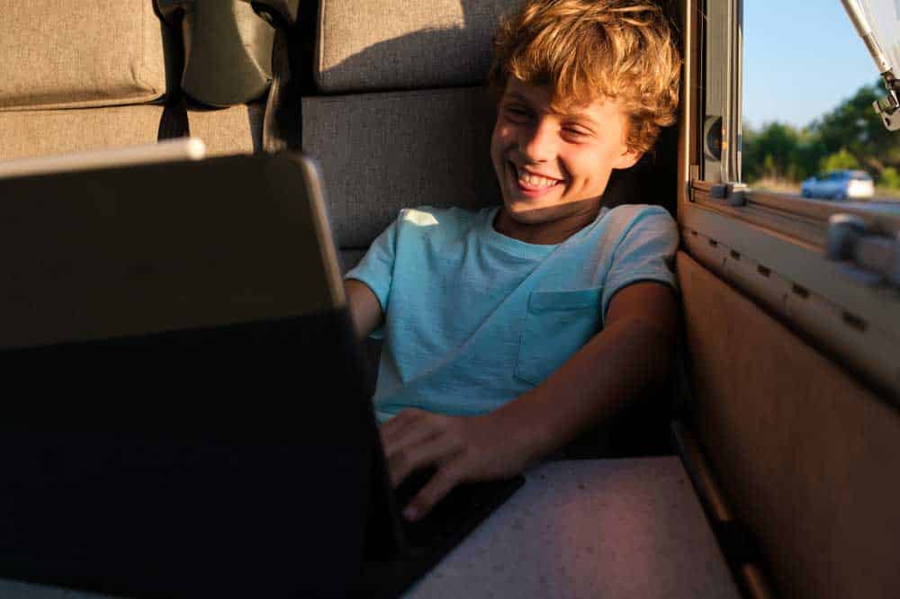 A young man browses while in an RV.
