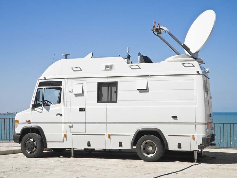 An RV traveling with a satellite dish