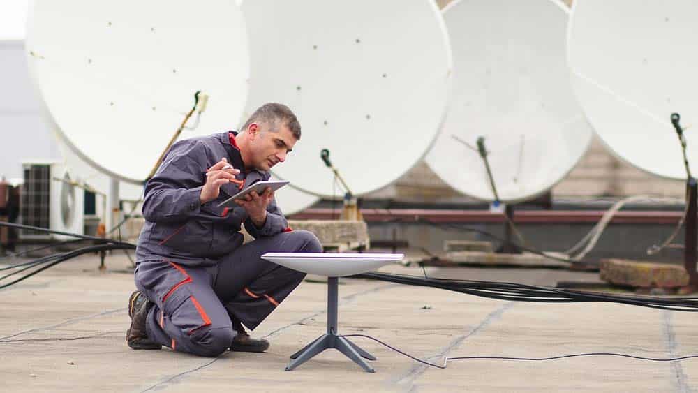 A man Installing a Starlink dish