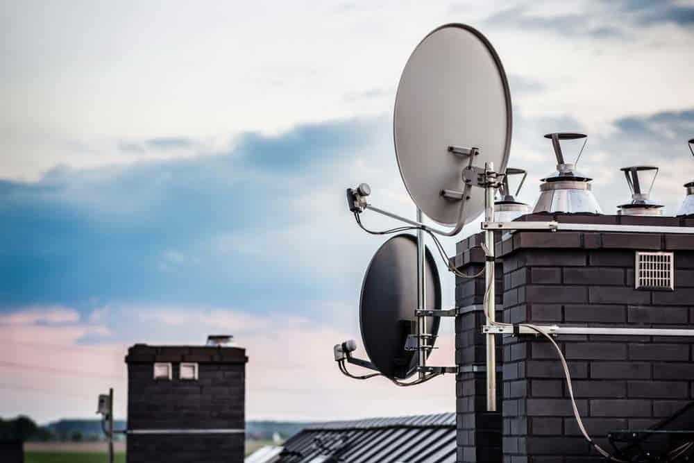 Rounded satellite dish mounted on the chimney